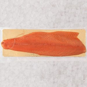 Filet de saumon fumé tranché sur une plaquette dorée